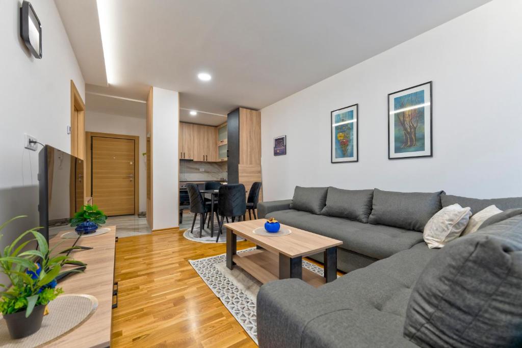 a living room with a couch and a table at Lux apartman 40 in Zlatibor