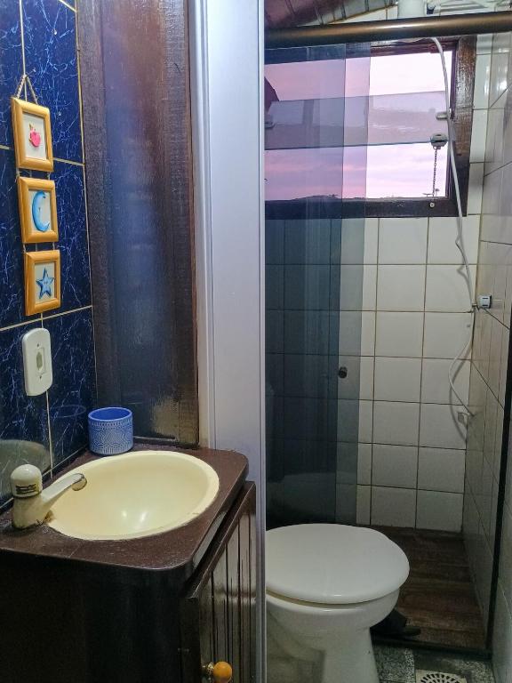 a bathroom with a toilet and a sink at Refugio de Mar in Búzios