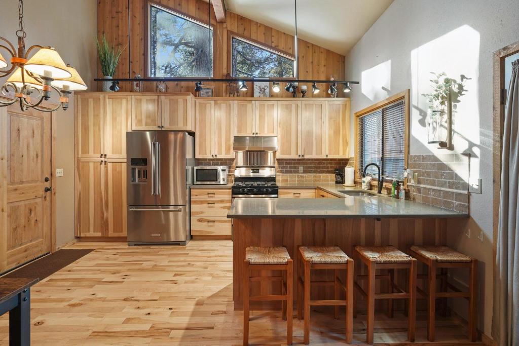 a kitchen with wooden cabinets and a stainless steel refrigerator at 14 Mt Hood in Sunriver