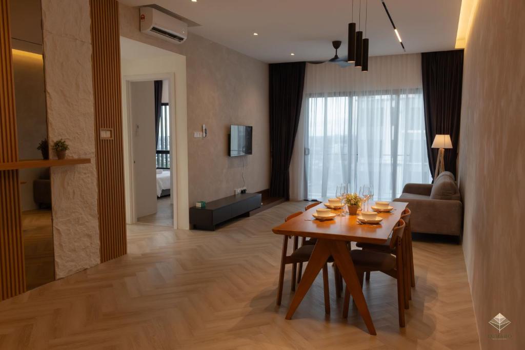 a living room with a table and a couch at Rumaho Upton by Elica Kuching in Kuching