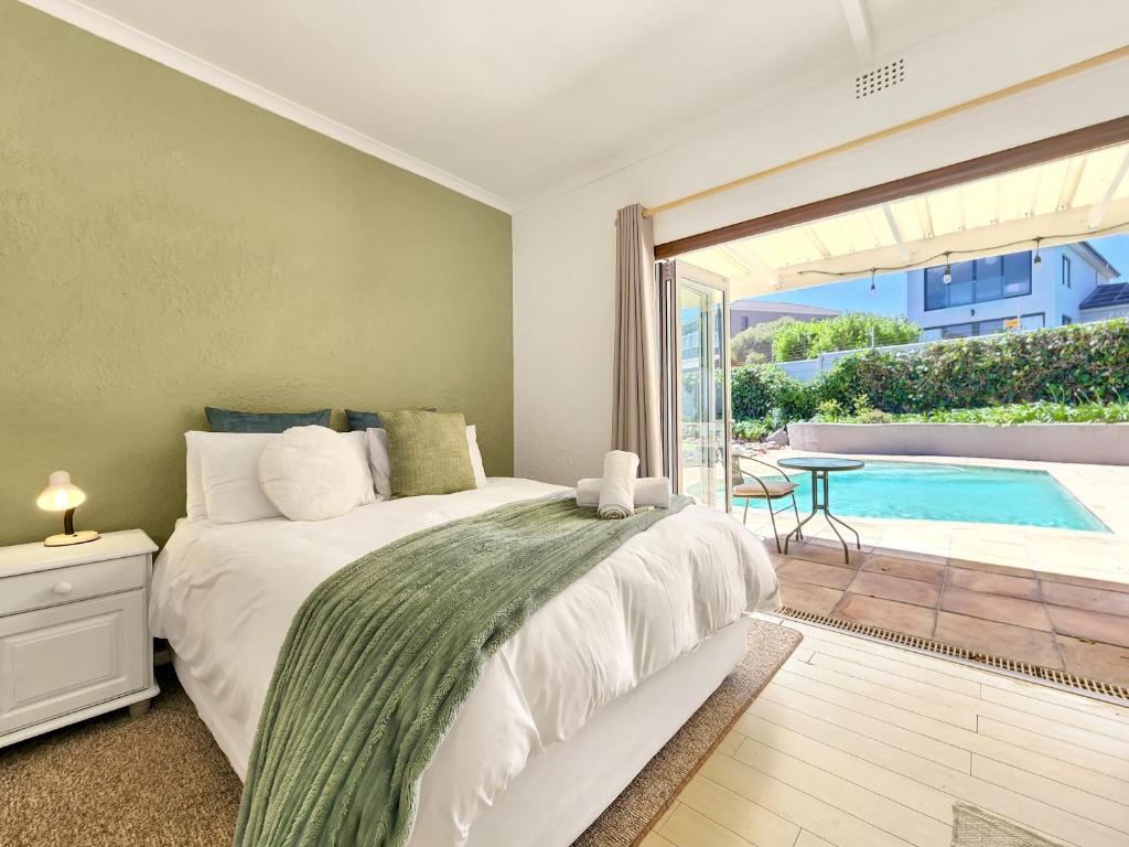 a bedroom with a bed and a pool at 70 on Brander in Cape Town