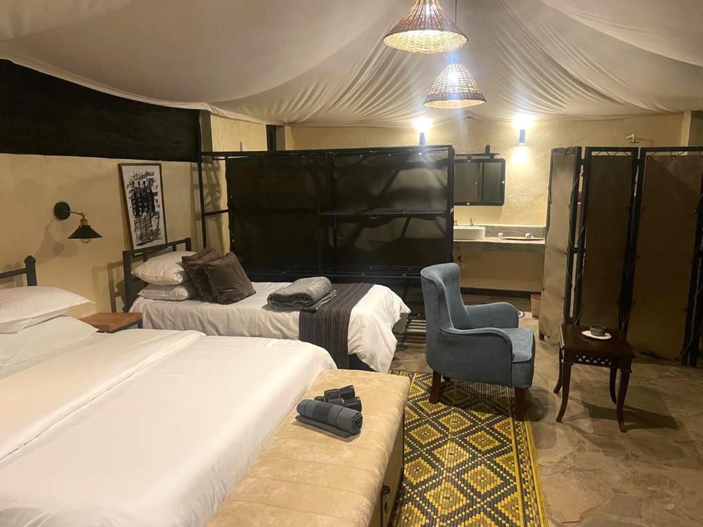 Ένα ή περισσότερα κρεβάτια σε δωμάτιο στο River Edge Lodge Masai Mara, Talek