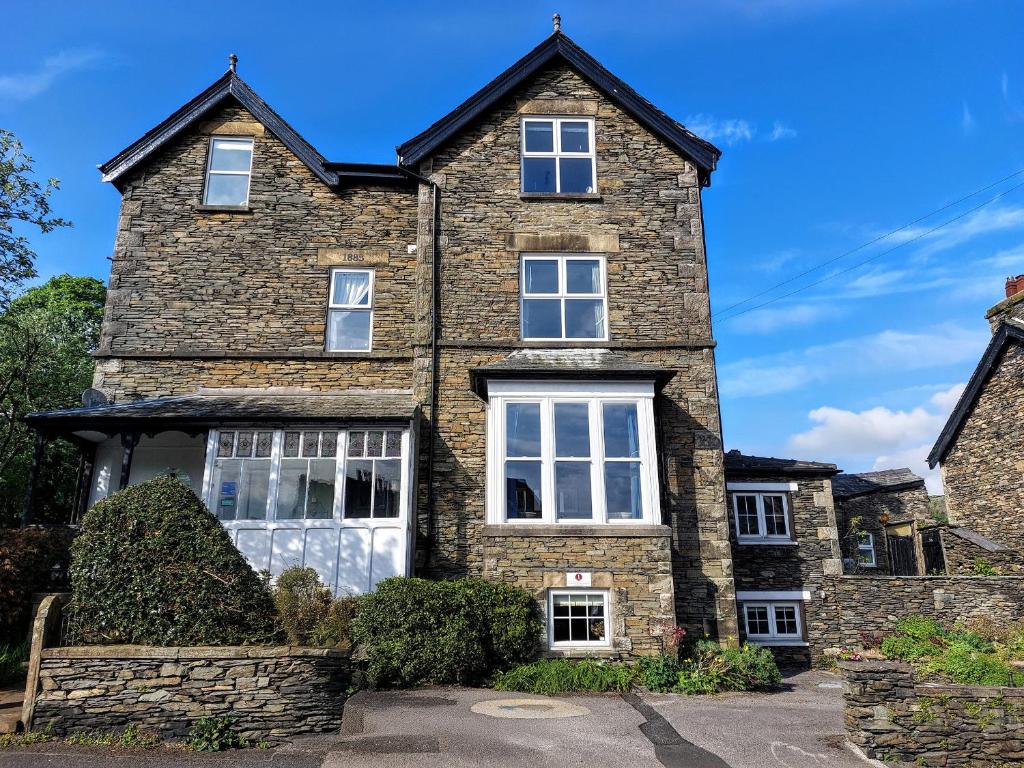 a large brick house with white windows at 1 Park Road in Windermere