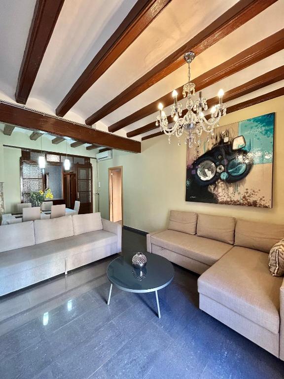a living room with couches and a chandelier at Font 1 Circo Romano in Tarragona