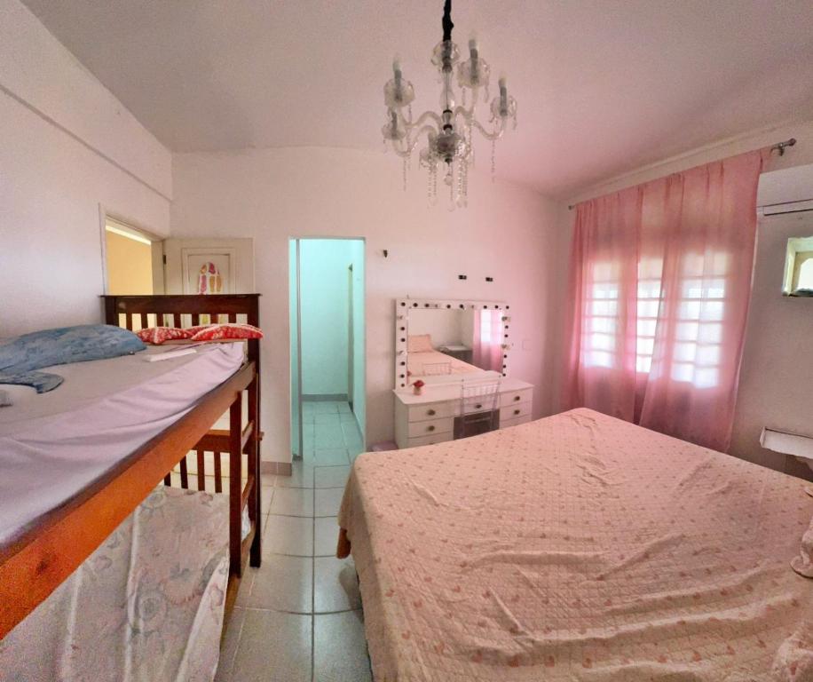 Una cama o camas en una habitación de Casa do Lago Salinópolis