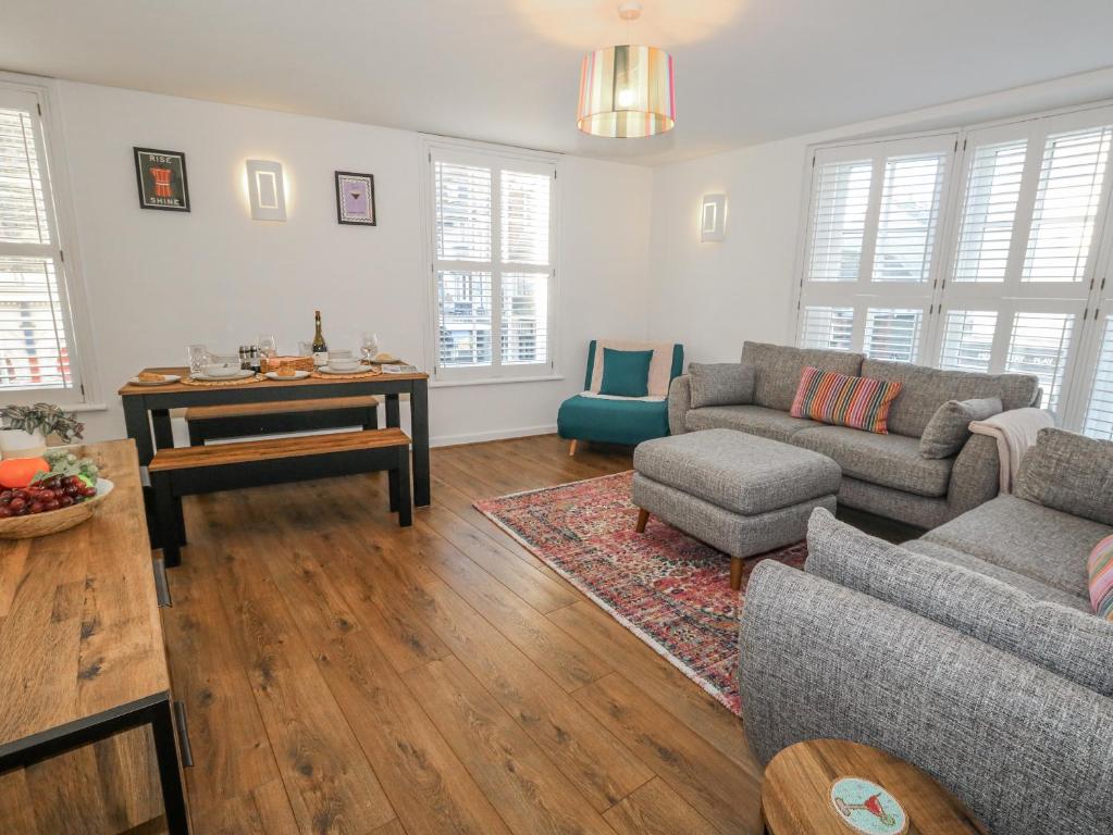 a living room with a couch and a table at Betty's Buoy in Weymouth