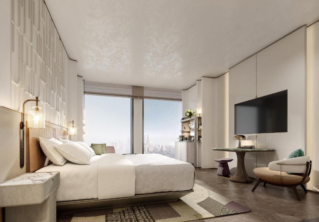 a bedroom with a white bed and a television at Vignette Collection TFT Chongqing by IHG in Chongqing