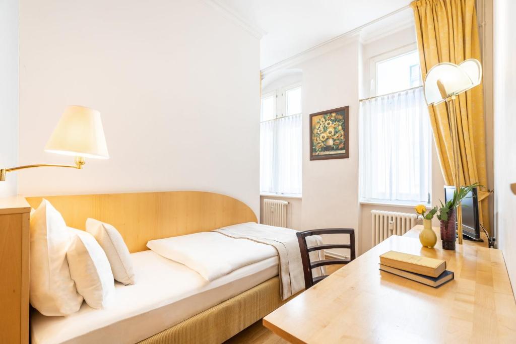a living room with a couch and a table at Garner Hotel Berlin - Messe by IHG in Berlin