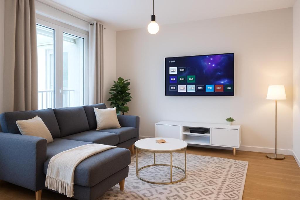 科尔贝埃索讷Omega Appartment的客厅里有一张沙发，墙上有一台电视