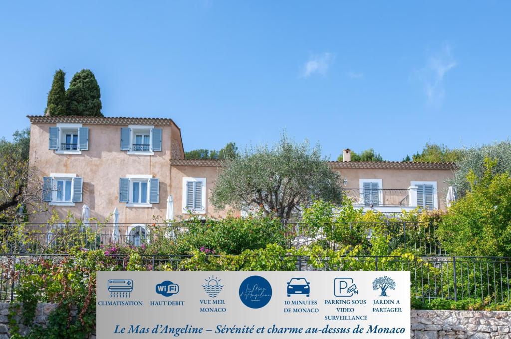 博索莱伊Le Mas d'Angeline-Vue mer panoramique, jardin partagé, parking, voiture indispensable, route étroite et pentue, à 10 min de Monaco的围栏后面的一栋建筑，前面立着一块牌子。