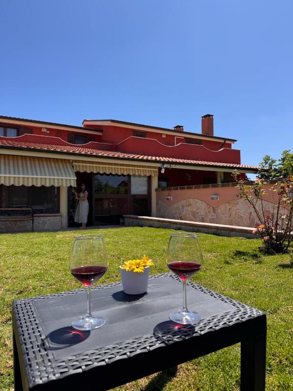 two glasses of wine sitting on a table at Villa Ninnì in Treglio
