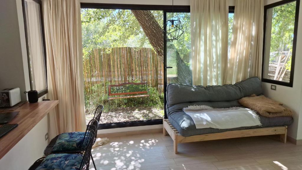 a living room with a couch and a large window at Casa XIII in Costa del Este