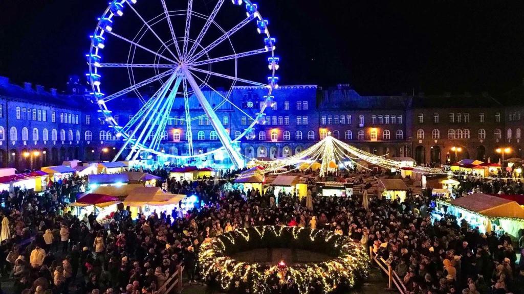 a large crowd of people standing in front of a ferris wheel at Downtown Dream Apartmans in Szeged