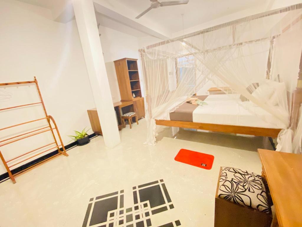 a bedroom with a bed with a mosquito net at Lavender mirissa in Mirissa