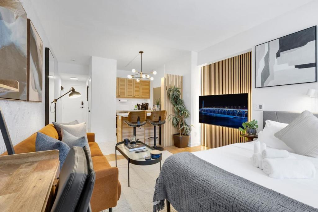 a bedroom with a bed and a living room at The Sherbrooke Suite 99 in Montreal