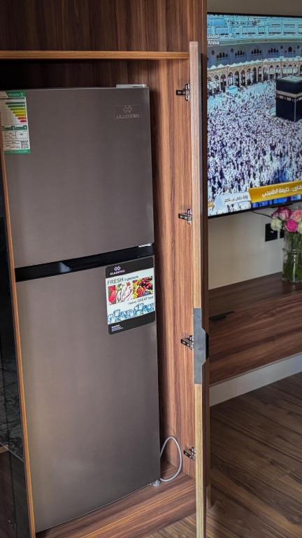 a refrigerator with a sticker on it in a kitchen at استوديو فندقي in An Nikāshah