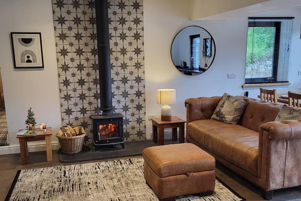 a living room with a couch and a fireplace at 3 Bed House - Sea Views Balcony Parking Pets in Innellan