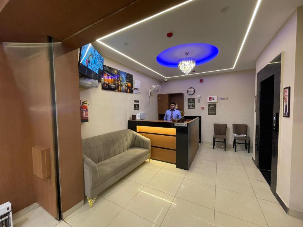 a man standing at a bar in a waiting room at The Rivanta Hotel Near Airport Road Mohali Zirakpur Chandigarh in Zirakpur