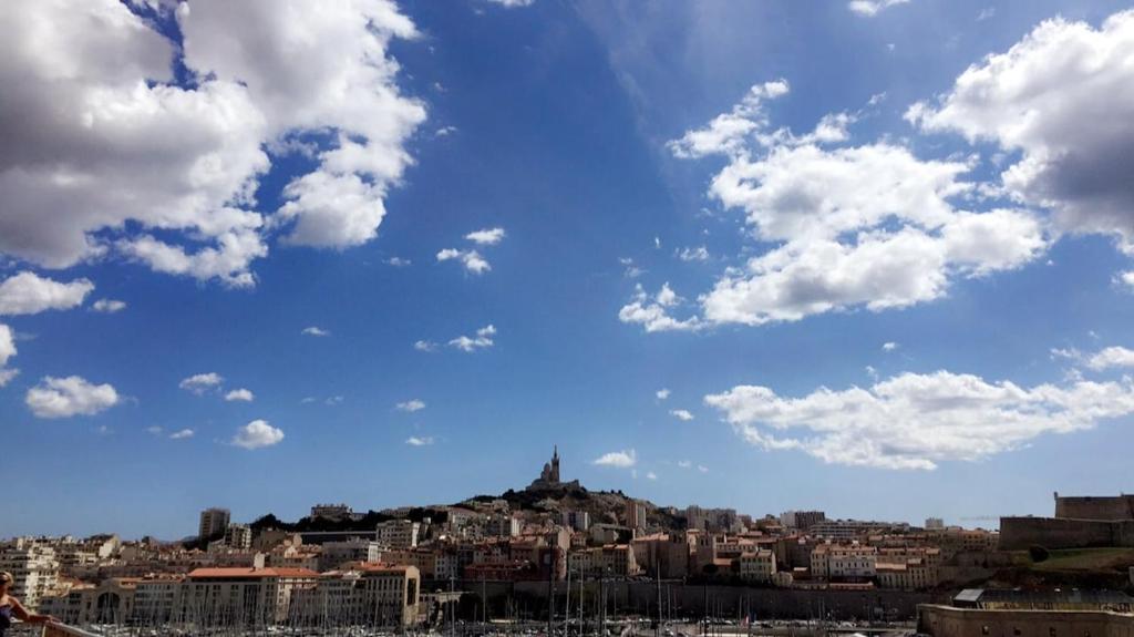 马赛La bonne mer的一座有建筑的城市,一片云 ⁇ 的蓝色天空