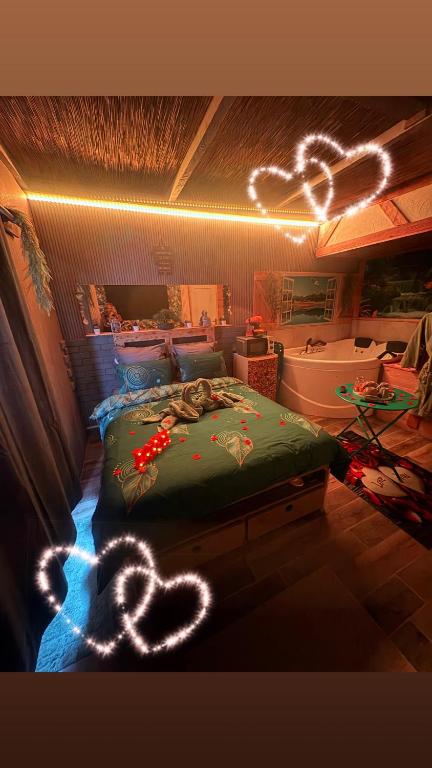 a bedroom with a bed with lights on it at Le doux refuge in Le Mont-Dore