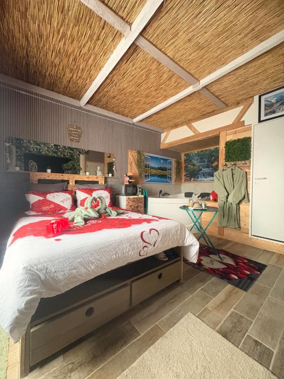 a bedroom with a large bed in a room at Le doux refuge in Le Mont-Dore