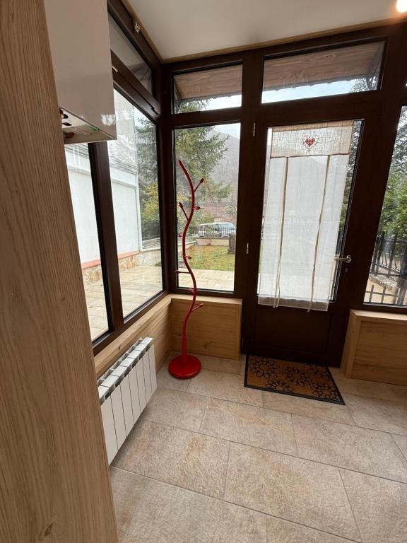 una stanza con una statua rossa davanti a una finestra di Rifugio di Peter a Castel di Sangro