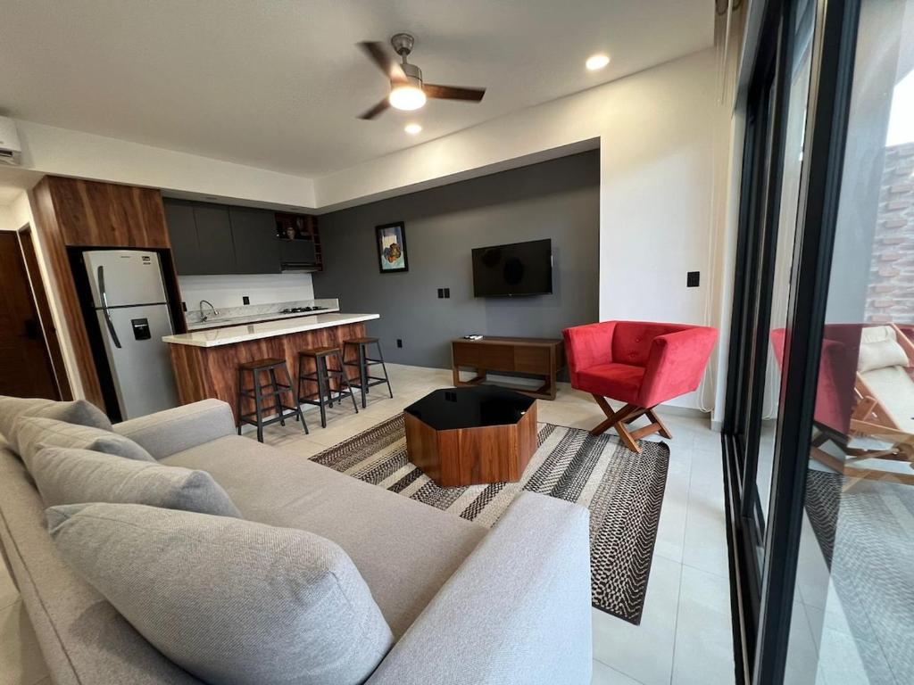 a living room with a couch and a kitchen at Place in the Romantic Zone with a Rooftop 301 in Puerto Vallarta