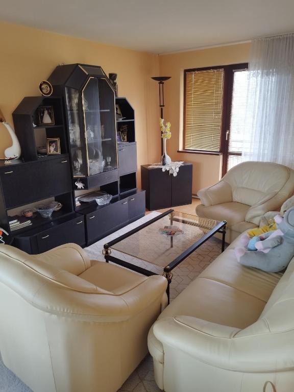 a living room with two couches and a coffee table at Вила Релакс in Pleven