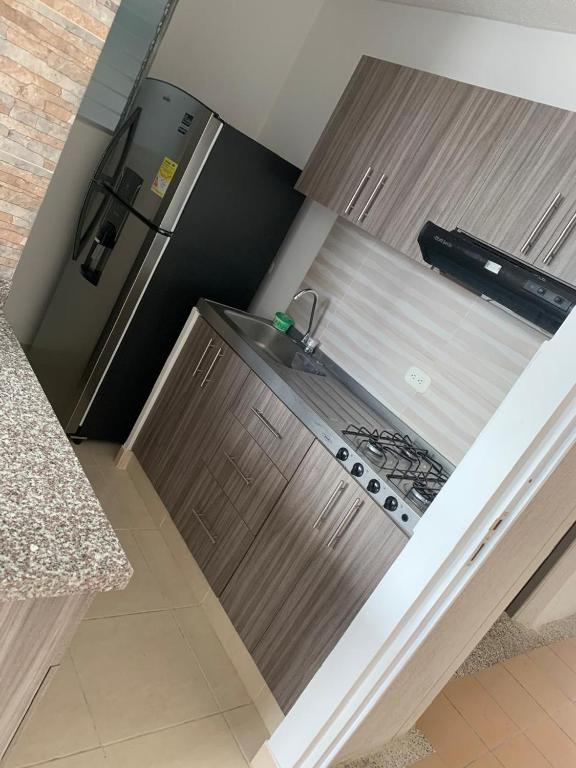 a kitchen with a sink and a stove at Apartamento amoblado en parque heredia in Cartagena de Indias