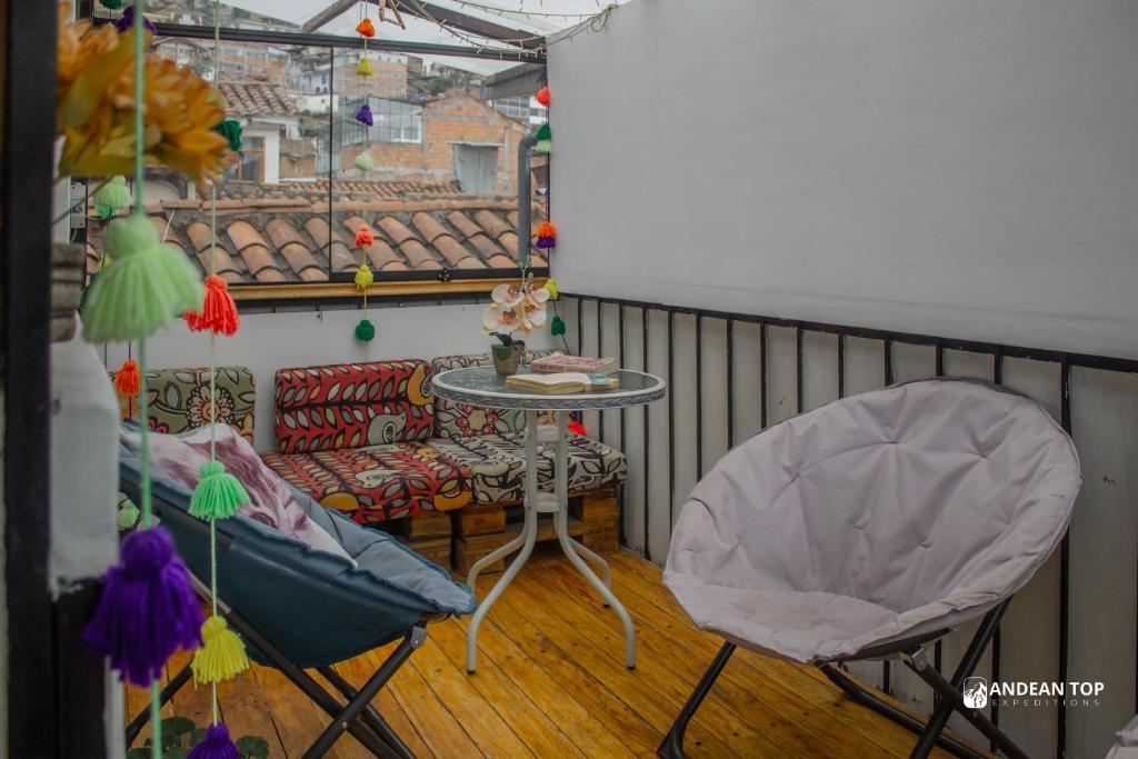 a balcony with a table and two chairs at Carmen Alto Inn Charming Private Rooms Steps from Downtown in Cusco