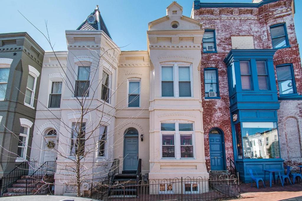 a building with a turret on a city street at Premier 5BR Historic Victorian Townhouse in Washington