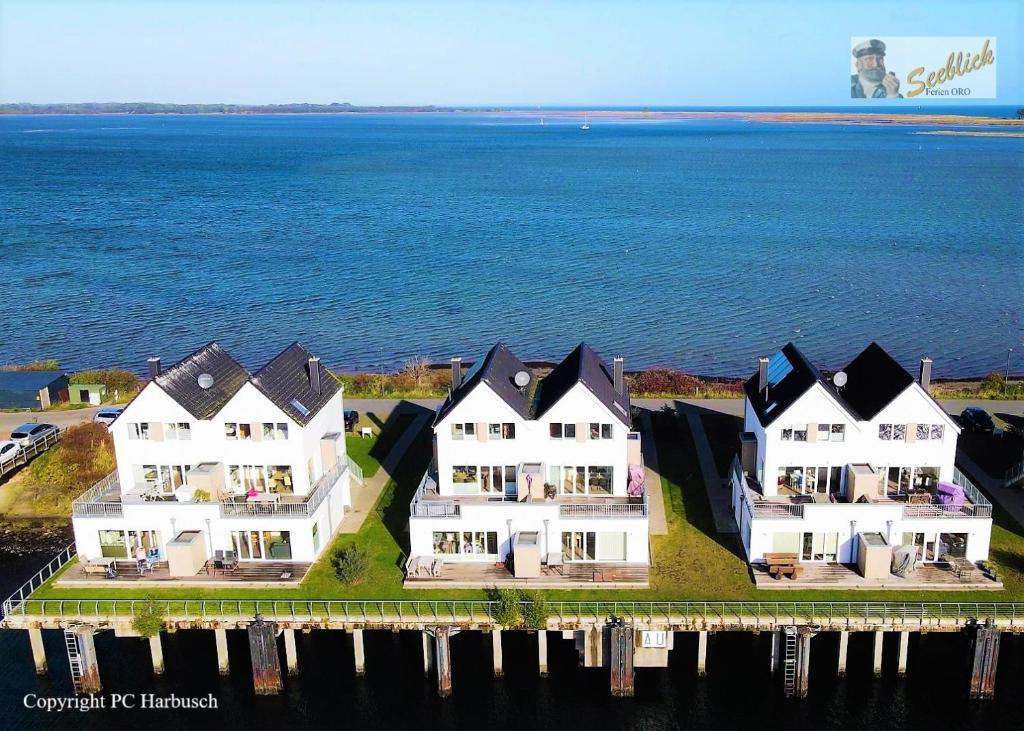 an aerial view of a house on the water at Kapteins Lounge by Seeblick Ferien in Olpenitz