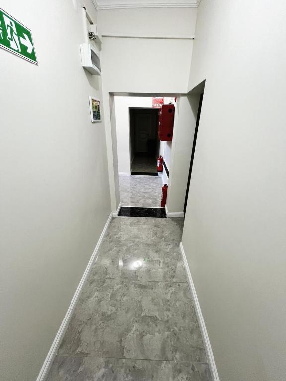 a hallway of an office with white walls and marble floors at Hevsel hotel in Diyarbakır