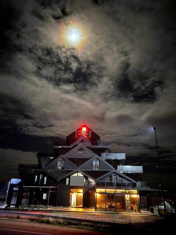 a building with a red light on top at night at Diamond Magic 2 Divcibare in Divčibare