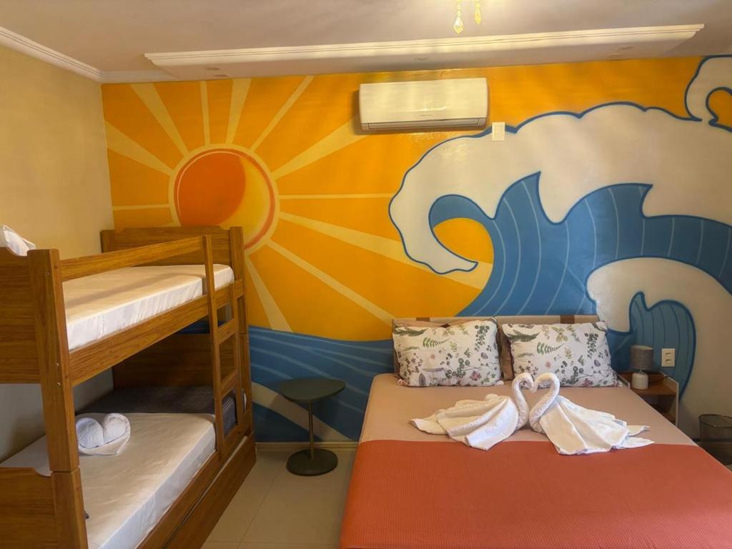 Ένα ή περισσότερα κρεβάτια σε δωμάτιο στο Casa ao mar -Pousada Itapema