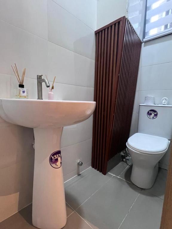 a bathroom with a sink and a toilet at HavenHomes 1 bedroom Apartment in Ikuata