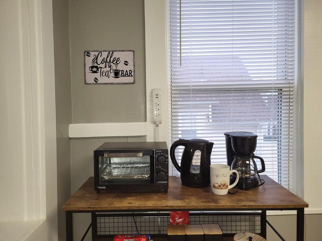 a microwave sitting on a table in a kitchen at Apt 2 2nd Floor in the Heart of the City in Worcester