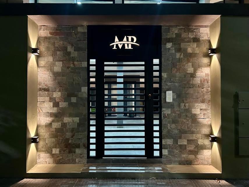 an entrance to a building with a sign on the door at MorenoPLAZA in Concepción del Uruguay