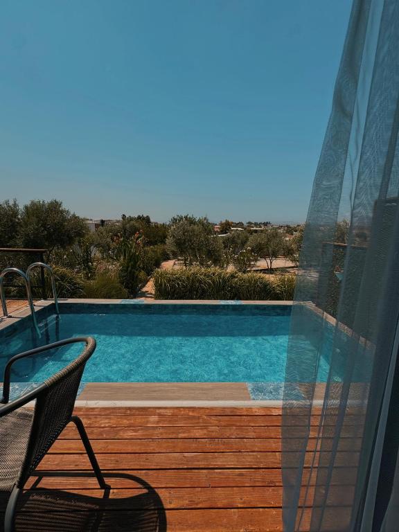 a view of a swimming pool from a balcony at majestic tiny home with private pool in Trikomo