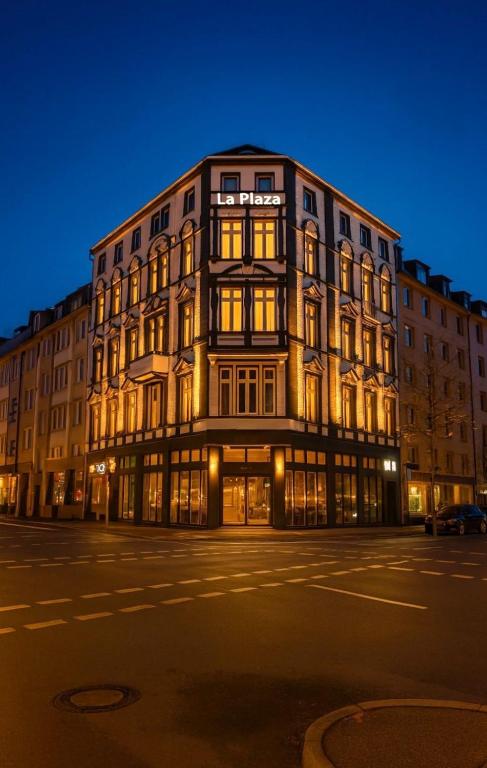a large building is lit up at night at la Plaza24 in Düsseldorf