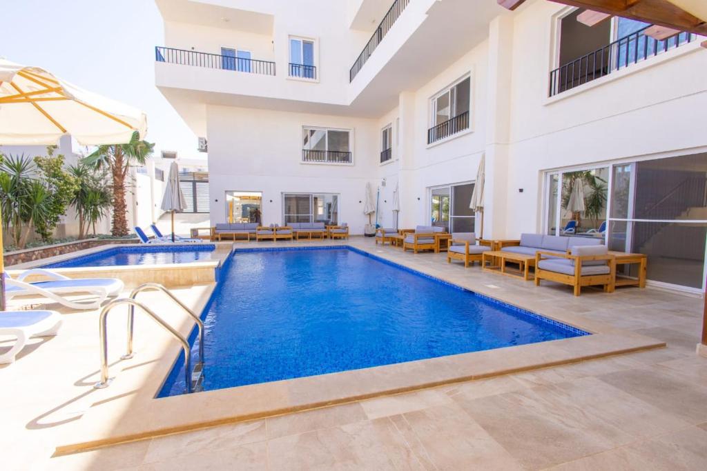 an image of a swimming pool in a villa at Family Nexus Hotel - Carefree in Hurghada