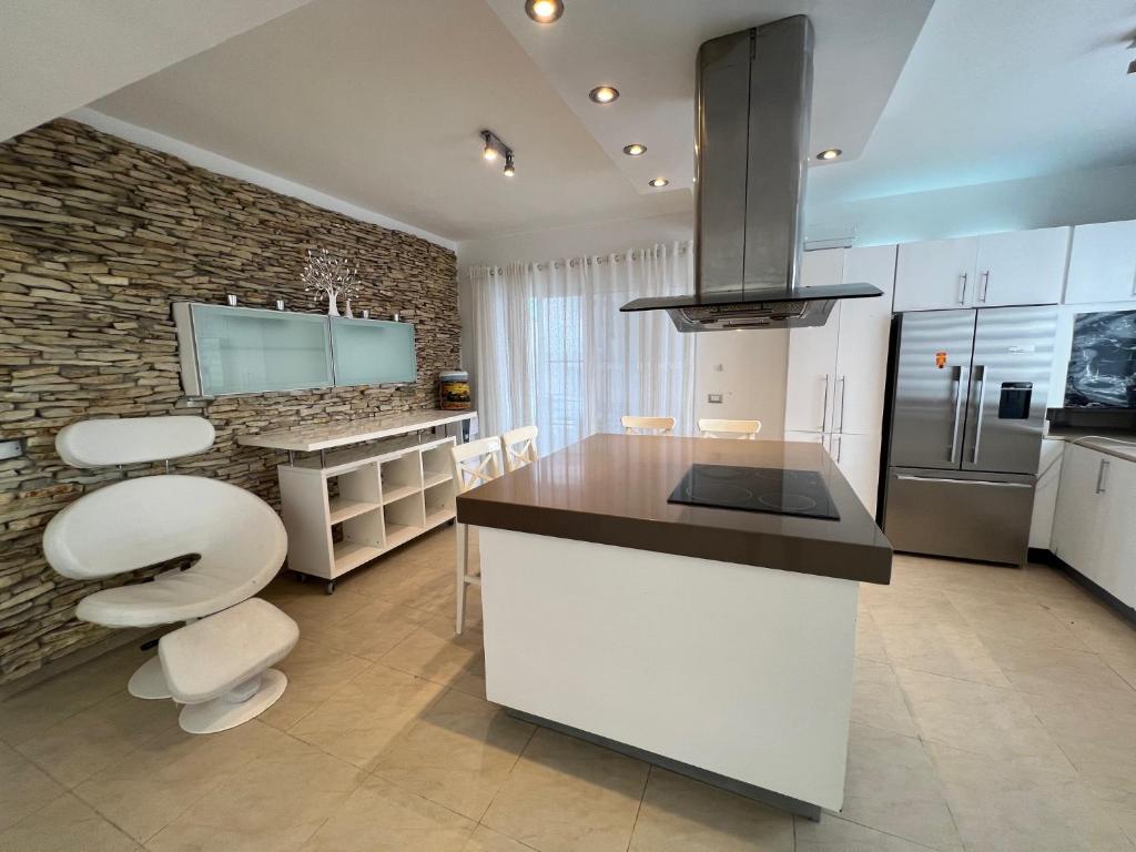 a large kitchen with a counter and a counter top at Condo cozy 1bdr 1bth in Punta Cana