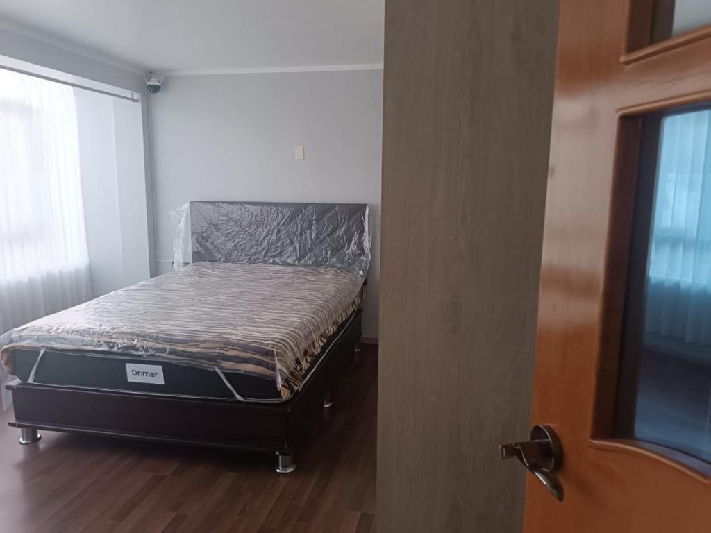 Ένα ή περισσότερα κρεβάτια σε δωμάτιο στο Puno- Departamento