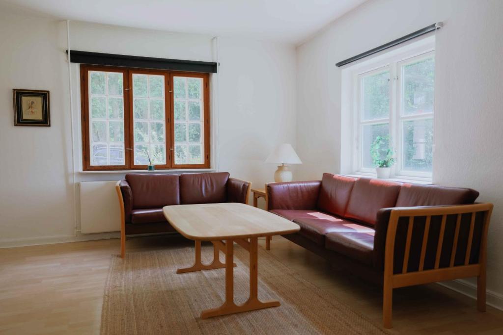 a living room with a couch and a table at Bright Modern Holiday Home Near Hindemae in Ullerslev
