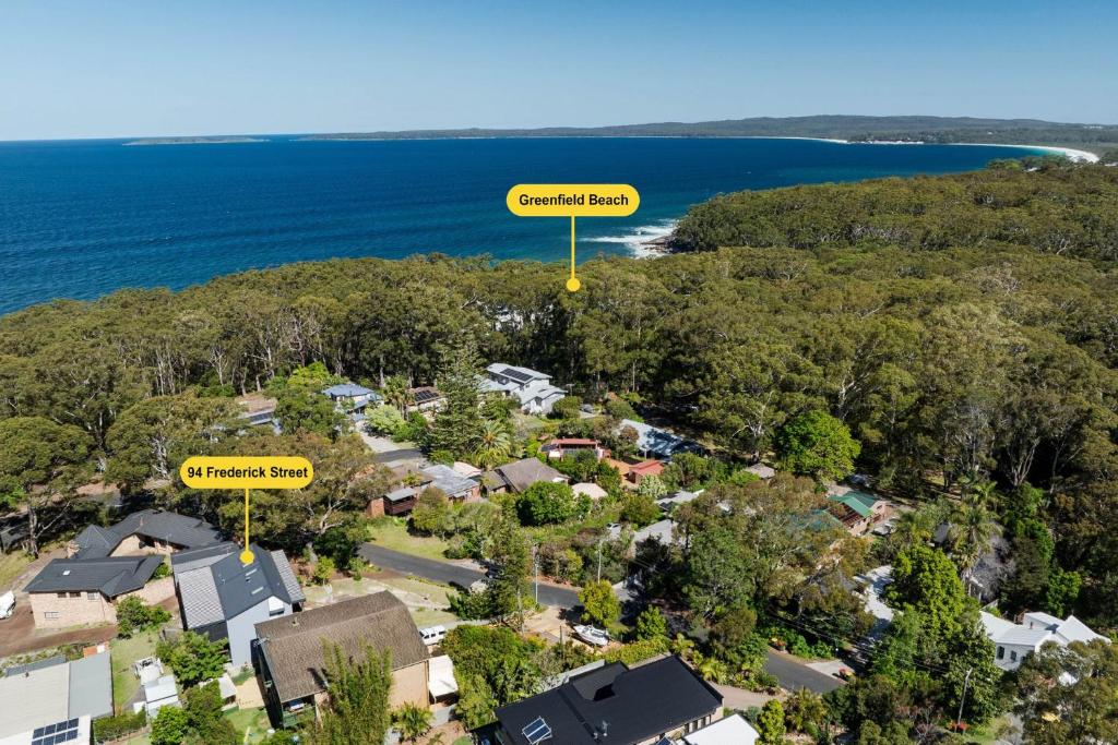 an aerial view of a suburb with houses and trees at Luna Beach House, Vincentia in Vincentia