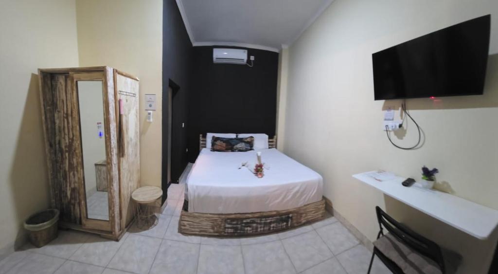 Una cama o camas en una habitación de Ceria House Ungasan Uluwatu