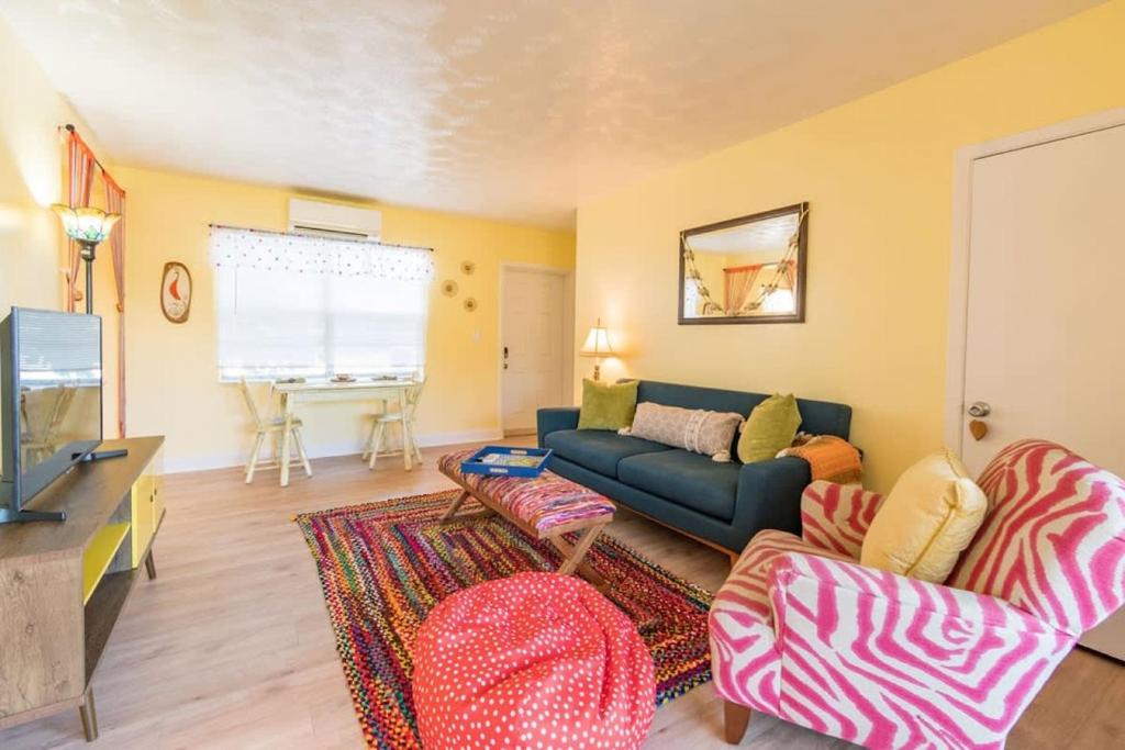 a living room with a couch and a table at Boho Cocoa Beach 1BR Steps to Beach in Cape Canaveral