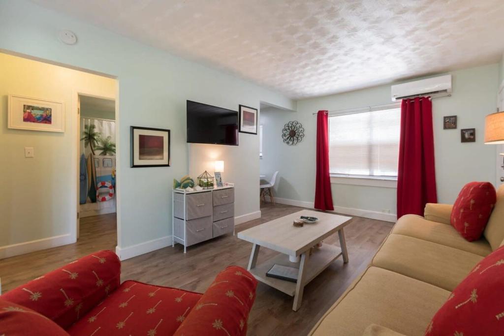 a living room with a couch and a table at 1BR Cocoa Beach Home - 1 Min to Beach in Cape Canaveral