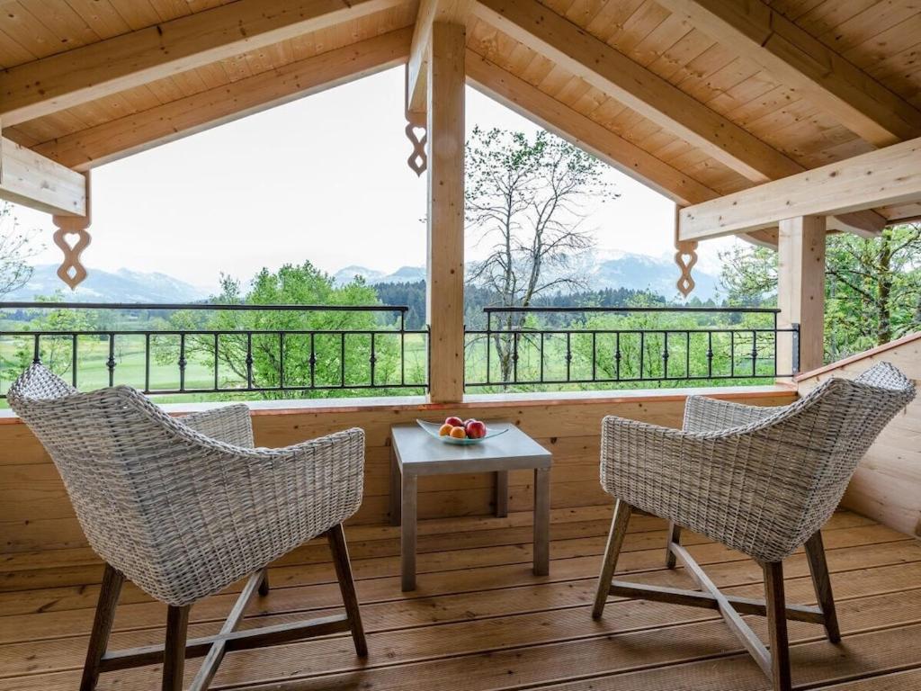 two chairs and a table on a porch with a view at Holiday apartment with 1 bedroom in Sigiswang