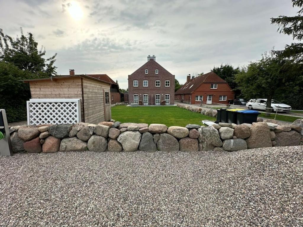 a stone fence in front of a house at The Linnebargs, House 2 in Bisdorf